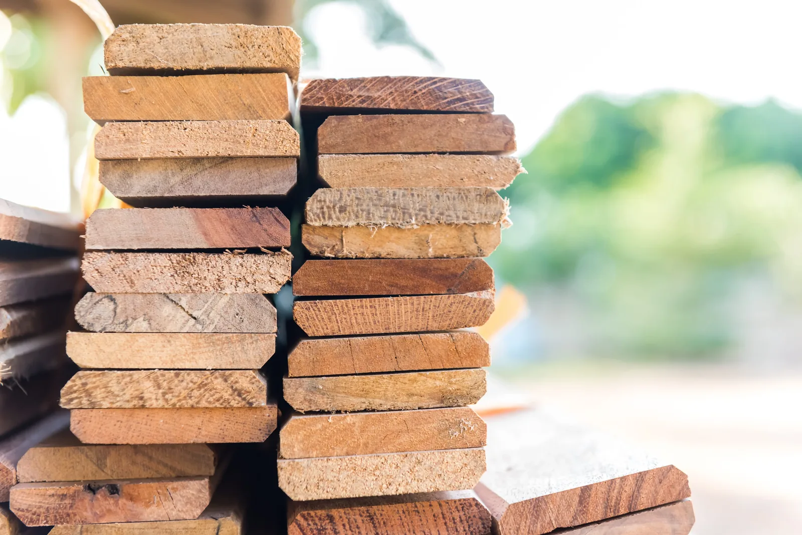 Two stacks of cut lumber boards outdoors