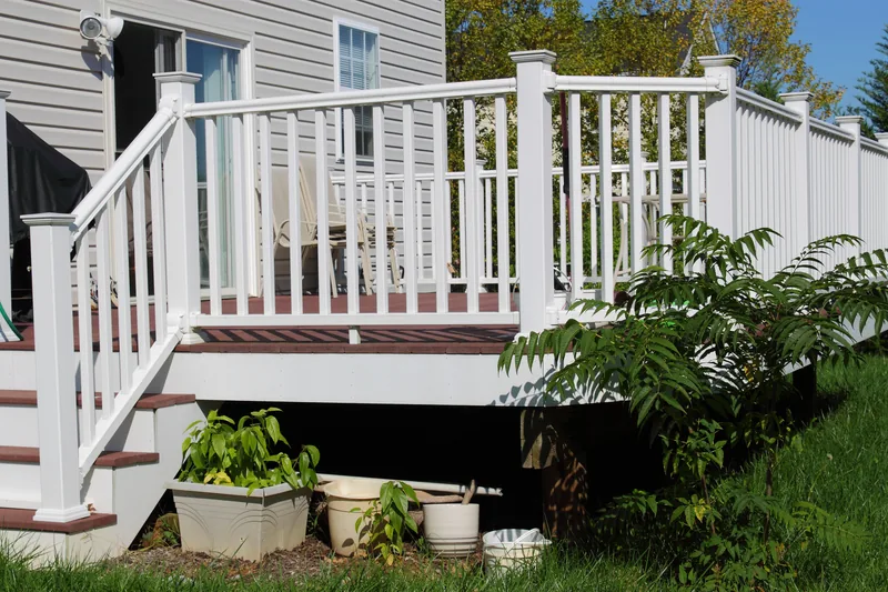 White vinyl deck railing and steps with lattice skirting
