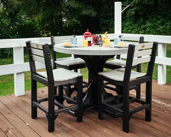 Black and white poly dining set on a deck with cups and a thermos