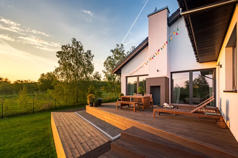 Composite deck at sunset with lounge chairs and string lights