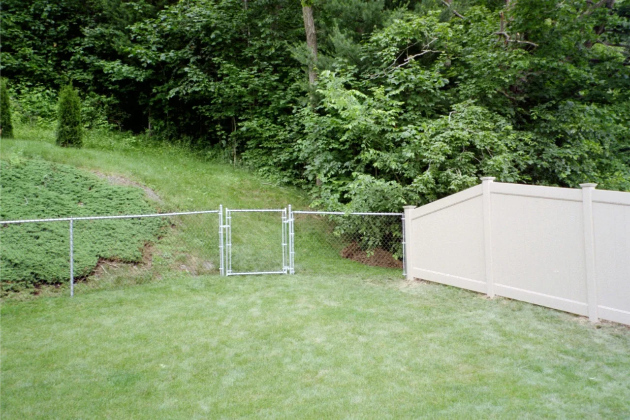 White vinyl fence along a suburban yard