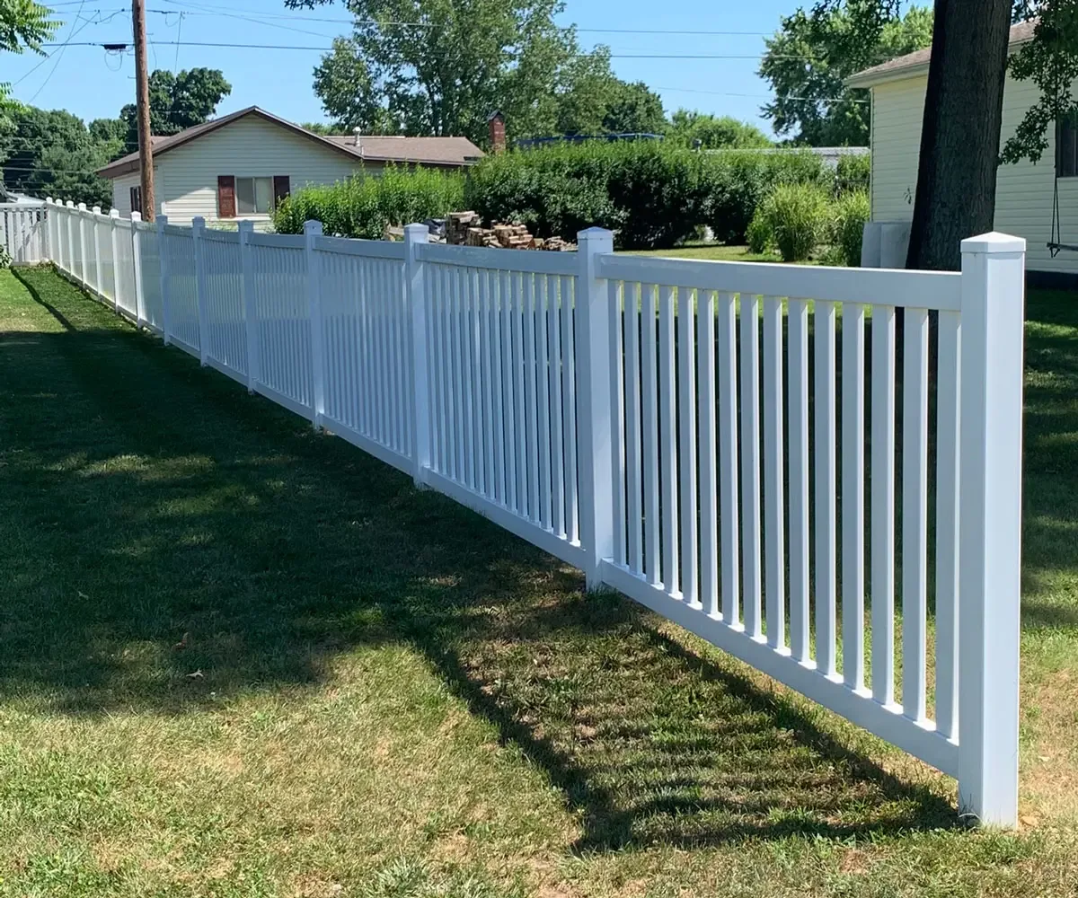 White vinyl semi-privacy fence with spaced pickets along a lawn